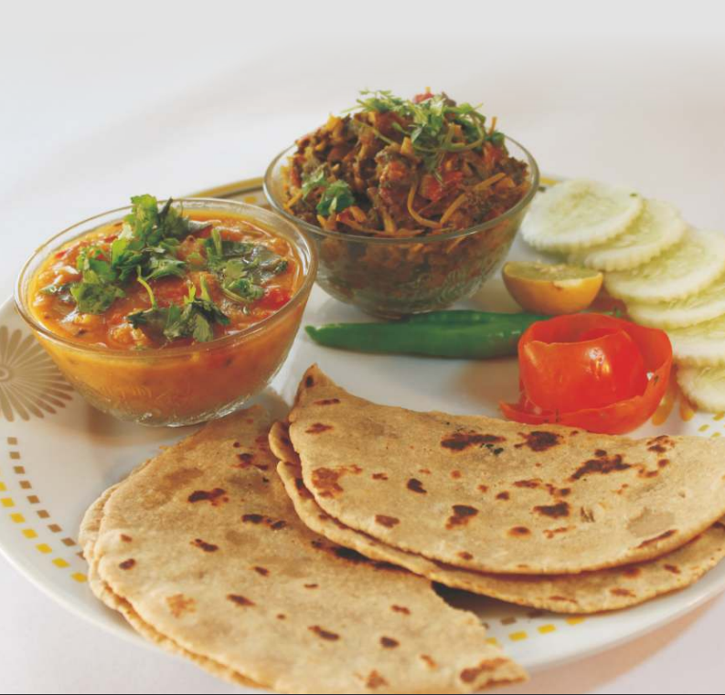 Jowar/Sorghum Roti with curry in a plate
